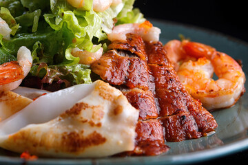 Seafood salad. Shrimps, eel, squids, lettuce. , close-up