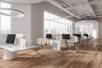 White open space office corner with round and rectangular tables