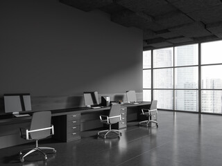 Workplace in gray industrial style office with blank wall