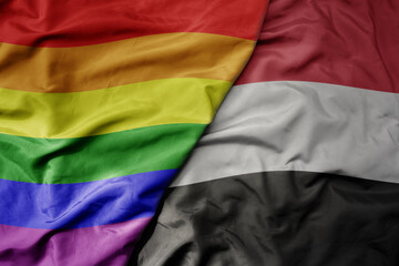 big waving realistic national colorful flag of yemen and rainbow gay pride flag .