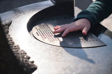 A child reads Braille for the blind with a small hand