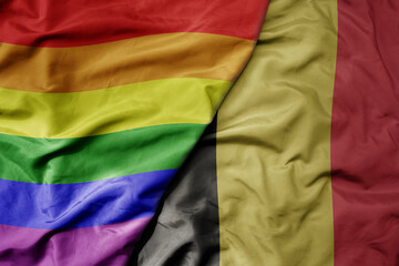 big waving realistic national colorful flag of belgium and rainbow gay pride flag .