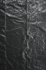 macro top shot of dark bin bag foil material with dust, nice photo overlay or background.