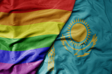 big waving realistic national colorful flag of kazakhstan and rainbow gay pride flag .