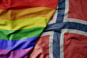 big waving realistic national colorful flag of norway and rainbow gay pride flag .