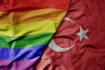 big waving realistic national colorful flag of turkey and rainbow gay pride flag .