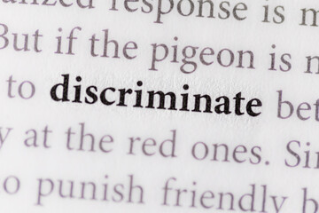 close-up of the term Discriminate on paper background 