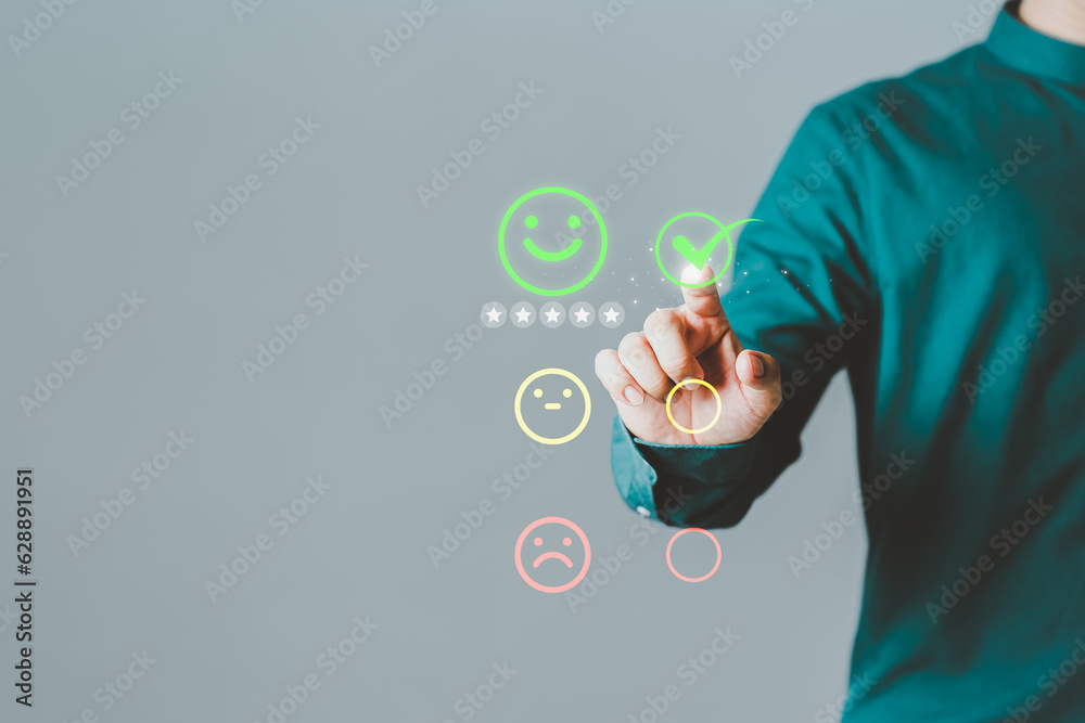 Poster customer's hand is touching virtual screen on the happy smile face icon to give satisfaction in serv