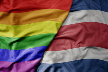 big waving realistic national colorful flag of costa rica and rainbow gay pride flag .
