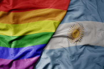 big waving realistic national colorful flag of argentina and rainbow gay pride flag .