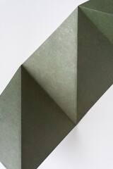 folded green paper with triangular forms