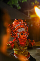 A Theyyam artist performs during the annual festival 