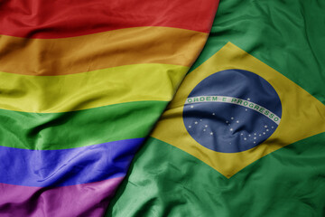 big waving realistic national colorful flag of brazil and rainbow gay pride flag .