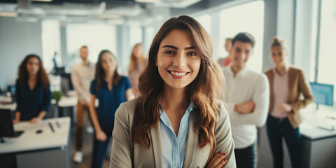 Obraz premium Portrait of a smiling young businesswoman posing in the office with her work partners in the background. Generative AI