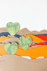 decorative hearts with foliage pattern on a pile of ripped paper with blank space