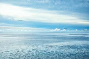 Cloudy blue sky over the blue sea in summer