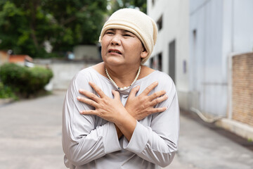 Terminally ill old senior woman cancer patient wearing grey chemotherapy hat, sickness pain relapse...