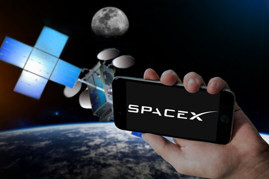 CHENNAI, INDIA, 29TH JULY 2023: SpaceX Logo In Holding Mobile Screen And Hughes Jupiter 3 Satellite Blur Background.