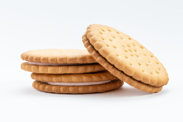 Stacked sandwich biscuits with pink cream filling. Sandwich cookies lie one on top of the other