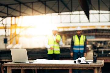 Engineering people on background. Safety Hard hat helmet, laptop computer and blue print paper plan. Construction Worker Planning Contractor