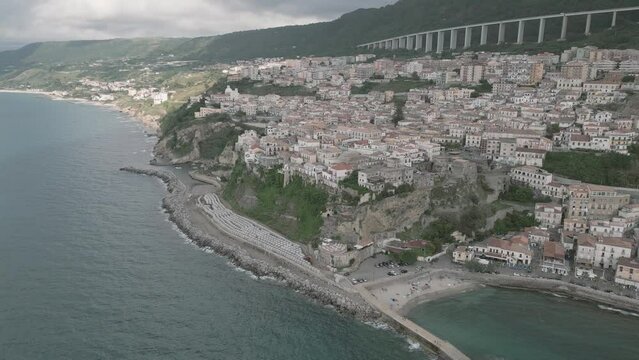 4k 25fps footage: aerial view of the medieval village of Pizzo in Calabria with its Murat castle, the Caribbean sea, the highway behind. The town is overlooking the sea.