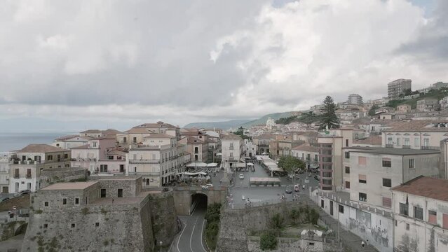 4k 25fps footage: aerial view of the medieval village of Pizzo in Calabria with its Murat castle, the Caribbean sea, the highway behind. The town is overlooking the sea.
