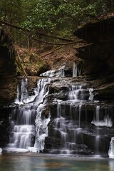 Icy waterfall in bankhead national forest surrounded by trees
