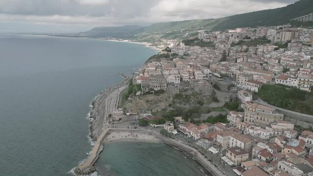 4k 25fps footage: aerial view of the medieval village of Pizzo in Calabria with its Murat castle, the Caribbean sea, the highway behind. The town is overlooking the sea.