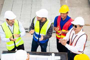 Group of professional Construction engineering people meeting and celebrate at Prefabricated concrete walls Industry Factory. Success teamwork. Ethnic diversity worker people. Unity and teamwork