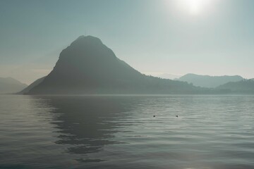 Naklejka na ściany i meble Tranquil lake reflecting the majestic mountains in the background