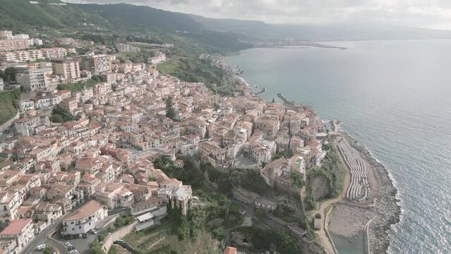 4k 25fps footage: aerial view of the medieval village of Pizzo in Calabria with its Murat castle, the Caribbean sea, the highway behind. The town is overlooking the sea.