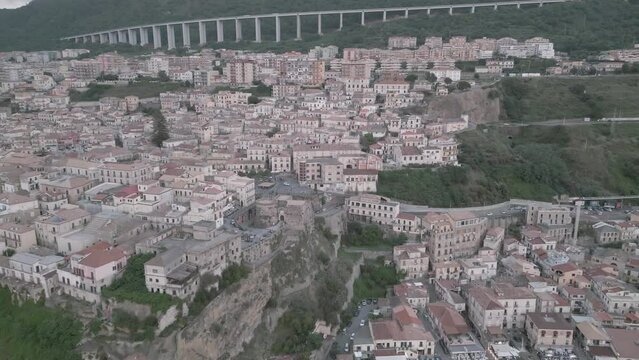 4k 25fps footage: aerial view of the medieval village of Pizzo in Calabria with its Murat castle, the Caribbean sea, the highway behind. The town is overlooking the sea.