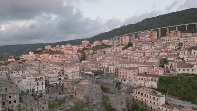 4k 25fps footage: aerial view of the medieval village of Pizzo in Calabria with its Murat castle, the Caribbean sea, the highway behind. The town is overlooking the sea.