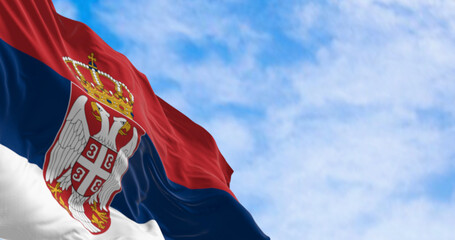 Nation flag of Serbia waving in the wind on a clear day