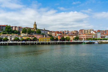 Fototapeta premium Portugalete town by Nervion river, and Sandra Maria basilica, Basque Country, Spain.