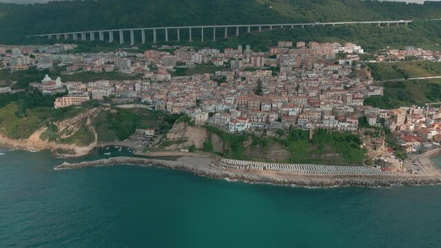 4k 25fps footage: aerial view of the medieval village of Pizzo in Calabria with its Murat castle, the Caribbean sea, the highway behind. The town is overlooking the sea.