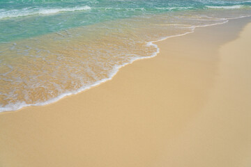 Fototapeta na wymiar Waves with foam on the Caribbean coast in Mexico.