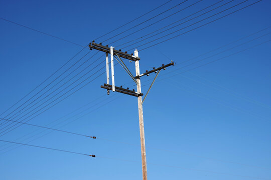 Electricity pylon under blue sky