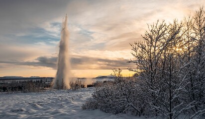 Breathtaking view of an icy snow-covered field in Reykjavik, Iceland during a stunning sunset - obrazy, fototapety, plakaty