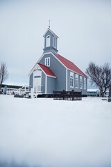 winter scene featuring a traditional church with a red roof and white windows in Reykjavik, Iceland