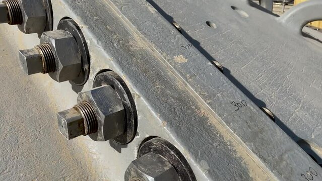 Bolted connection of parts of a ball mill close up. Copper processing plant equipment