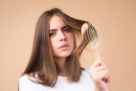 Hair loss woman with a comb and problem hair. Hairloss stressed woman and bald problems.