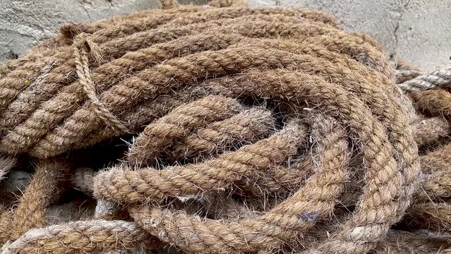 coil of old brown nautical rope close-up