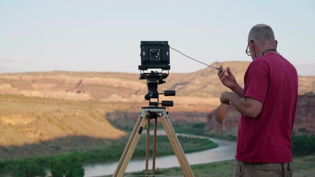 Old wildlife photographer getting ready and turning on his devices