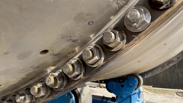 Bolted connection of parts of a ball mill close up. Copper processing plant equipment