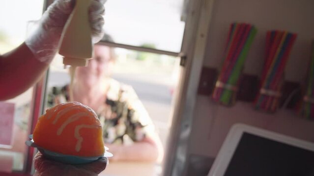 Worker selling and making fruity shaved ice