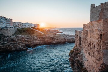 Picturesque landscape of a coastal cliff face and buildings Polignano a Mare, Puglia, Italy