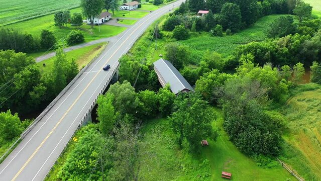 Aerial view of Joseph Edouard Perrault Covered Bridge in Quebec, Canada 4k