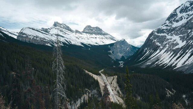 Timelapse of a Scenic drive on a beautiful highway, Icefields Parkway, through the Canadian Rockies during a vibrant summer day. Located in Banff National Park, Alberta, Canada.