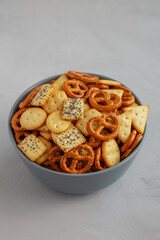 Homemade Party Snack Mix with Crackers and Pretzels in a Bowl, side view. Close-up.